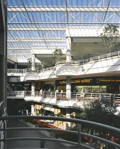 the inside of a shopping mall with people walking around