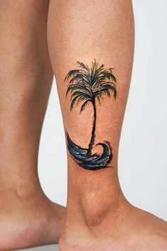 a person with a palm tree tattoo on their leg