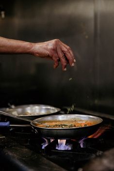 a person cooking food on top of a stove