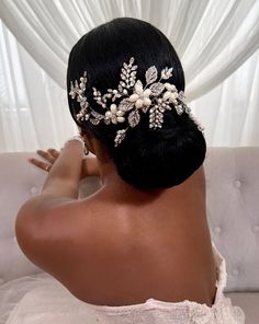 the back of a woman's head wearing a bridal hair piece