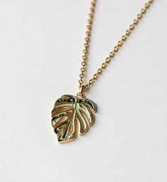 Perfect gift for the plant mom and nature enthusiast! This necklace is crafted in 18k gold plated over sterling silver. | Inspired by my very own Monstera deliciosa Albo, this gorgeous Monstera Deliciosa leaf necklace is plated in 18K Gold and has a Mirror- like finish. A perfect stunning necklace gift for nature enthusiast. | 1-800-Flowers Gifts Delivery Variegated Monstera Thai Constellation Necklace 18K Gold Yellow Gold Leaf Shape Nature-inspired Jewelry, Leaf-shaped Yellow Gold Necklace, Yellow Gold Leaf Necklace As Gift, Yellow Gold Leaf Necklace For Gift, Leaf-shaped Yellow Gold Necklace For Gift, Sterling Silver Leaf-shaped Jewelry In Yellow Gold, Nature-inspired Gold Jewelry With Birth Flower, Yellow Gold Leaf-shaped Jewelry Gift, Gold Nature-inspired Necklace For Gift