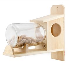 a wooden bird feeder with nuts in it