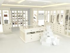 a large white closet with lots of clothes on shelves and drawers in the center,