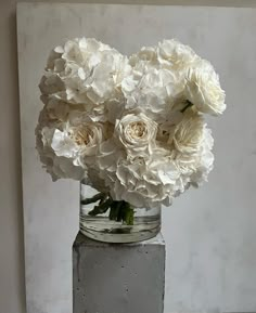 a vase filled with white flowers on top of a table