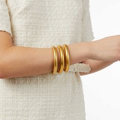 Elegant yet simple, this statement-making golden bangle features a lightly hand-hammered finish. An ornately geometric piercework interior adds lightness and luxury for wearing stacked or solo. Luxury Statement Bangle, Luxury Heavy Gold Bangle, Luxury Gold Plated Statement Bangle, Luxury Brass Bangle, Polished Yellow Gold Brass Bangle, Golden Bangles, Active Wear Dresses, Arm Accessories, Julie Vos