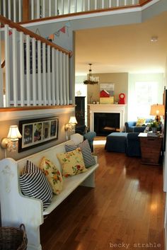 a living room filled with furniture and a fire place under a stair case next to a fireplace