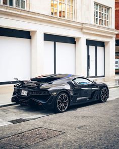 a black sports car parked in front of a building