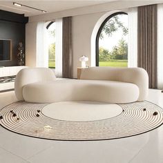 a modern living room with white furniture and large round rugs on the floor in front of windows