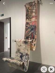 a skateboard sitting on top of a chair in a room with white walls and black flooring