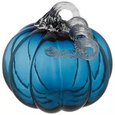 a blue glass pumpkin sitting on top of a white table