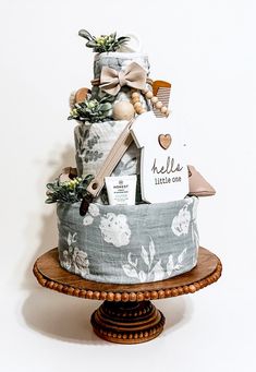 a baby gift basket on top of a wooden stand