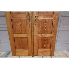 two wooden doors with metal handles on each side