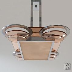 a modern light fixture hanging from the ceiling