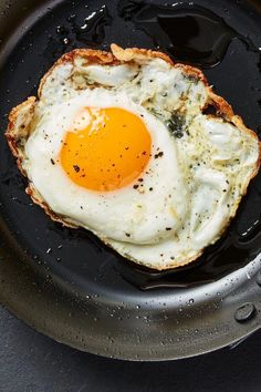 an egg frying in a skillet on top of a table