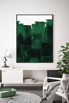 a living room with a large green painting on the wall and a white chair next to it