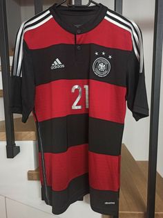 a soccer jersey is hanging on a rack