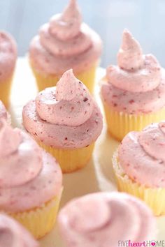 cupcakes with pink frosting on a white plate