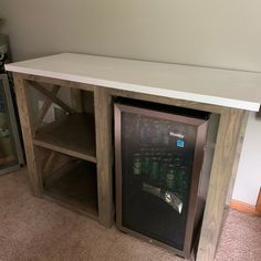 a wooden cabinet sitting on top of a carpeted floor next to a white wall