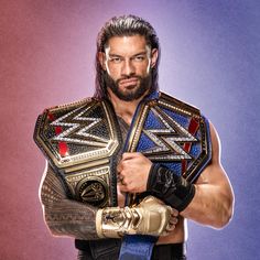 a man with a beard holding a wrestling belt