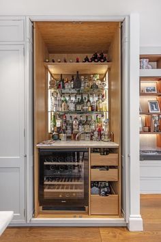 an open cabinet filled with lots of bottles