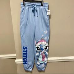 Step Up Your Casual Style With These Disney Stitch Powder Blue Joggers. These Sweatpants Are Perfect For Lounging At Home Or Running Errands Around Town. With A Comfortable Fit And Trendy Jogger Style, These Pants Will Quickly Become Your Go-To Choice. Featuring A Fun Disney Stitch Design, These Juniors-Sized Pants Are Sure To Turn Heads. The Blue Color And Jogger Style Add A Trendy Touch To Your Wardrobe, While The New With Tags Condition Ensures That You're Getting A High-Quality Item. Don't M Stitch Pants, Trendy Joggers, Quilted Pants, Disney Pants, Graphic Sweatpants, Blue Lounge, Fleece Pajama Pants, Lounge Pants Womens, Mickey Mouse Sweatshirt