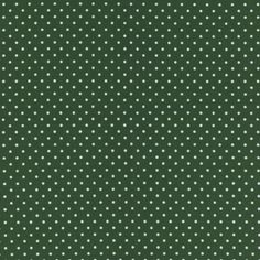 a green background with white polka dots