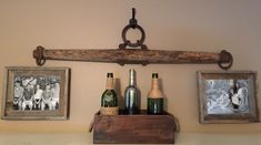 three framed pictures hang on the wall above wine bottles and corks in an old wooden box