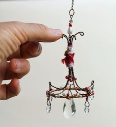 Enhance the enchanting ambiance of your doll house with this exquisite and elegant doll house mini chandelier crystal suncatcher.  This miniature wonder is meticulously crafted with precision and attention to detail. The sparkling crystal beads reflect the light beautifully, creating a mesmerizing display of shine and charm.  Hang this enchanting suncatcher in any room or corner of your doll house to instantly elevate its elegance and sophistication.  With its petite size, it is the perfect addition to any dollhouse miniatures collection.  Approximate measurements:  length 5"  width 2.5"  ❤Please click on the link to view more petite charms : https://www.etsy.com/il-en/shop/MammaEarthCreations?ref=pr_shop_more&section_id=43438654 ❤Keep shopping - My main shop page: https://www.etsy.com/il- Walnut Shell Crafts, Miniature Home, Fairy Gifts, Chandelier Crystal, Crystal Suncatcher, Fairy Garden Houses, Walnut Shell, Mini Chandelier, Crystal Suncatchers