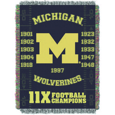 the michigan wolverines woven throw blanket has been designed to look like an old football team logo