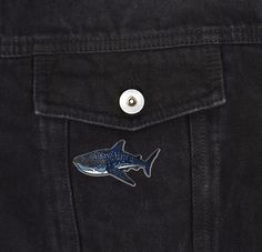 a shark sticker on the back of a black jeanie jeans pocketed in