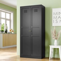 a tall black cabinet in a green room