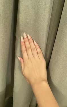 a woman's hand on top of a curtain