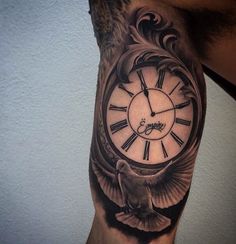 a man's arm with a clock and dove tattoo on it, next to a white wall