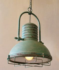 an old fashioned light hanging from a chain