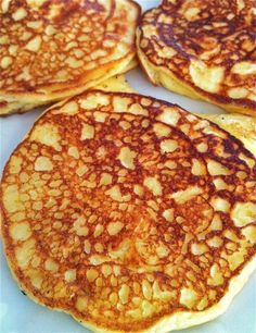 four pancakes sitting on top of a white plate