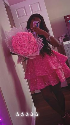 a woman taking a selfie with her cell phone and holding a bouquet of flowers