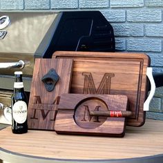 a wooden cutting board sitting on top of a table next to a bottle of wine