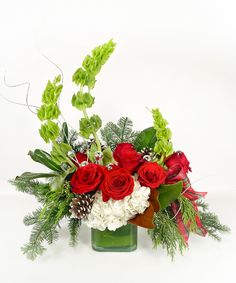 a vase filled with red and white flowers