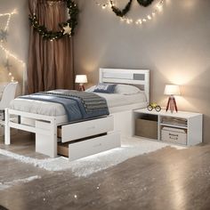 a white bed sitting in a bedroom next to a night stand with lights on it