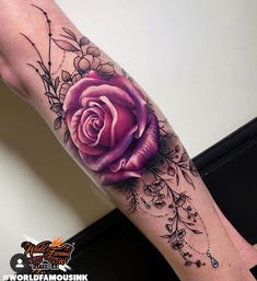 a woman's leg with a purple rose tattoo on the left side of her arm