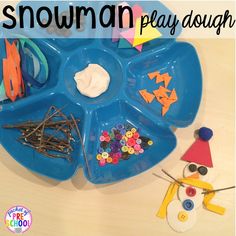 a snowman play dough tray with craft supplies