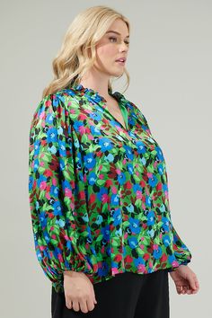 Add a pop of a colorful touch to your outfit of the day with the Destine Floral Hathaway Split Neck Long Sleeve Blouse! It features a ruffle split neckline framed by billowing balloon sleeves. The bodice maintains a relaxed fit and can be styled tucked into your favorite high waisted pants. This top is perfect for anything from day parties to dinner with friends.- Split neckline- Elastic cuffs - Lined- Balloon sleeves- Color: Green blue fuchsiaSize + Fit - Model is 5'8" and wearing size XS- Meas Green Top With Vibrant Print For Fall, Vibrant Green Blouse For Spring, Spring Printed Split Neck Blouse, Vibrant Green Fall Top, Multicolor Long Sleeve Blouse With Bold Print, Multicolor Floral Print Blouse With Split Neck, Vibrant Green Spring Tops, Pink Floral Print Split Neck Blouse, Green Blouse With Vibrant Print