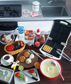 an assortment of food is sitting on the counter next to some utensils and other items