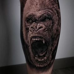 a man's leg with an angry gorilla tattoo on the side of his leg