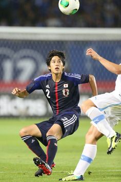 two men are playing soccer on the field