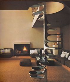 a living room filled with furniture and a fire place in the middle of the room