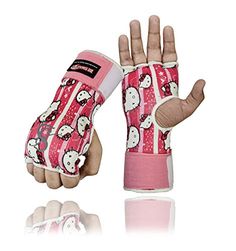 a pair of pink hello kitty gloves is shown with one hand in the air and two fingers out