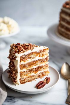 a piece of cake on a plate with pecans around it and two forks next to it