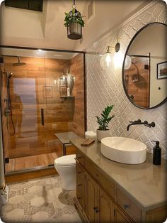 a bathroom with a sink, toilet and shower stall in it's own area