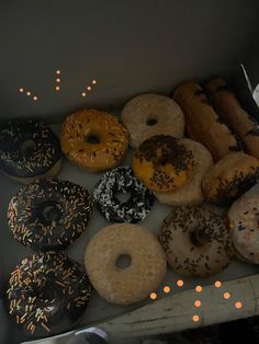 a box filled with lots of different flavored donuts